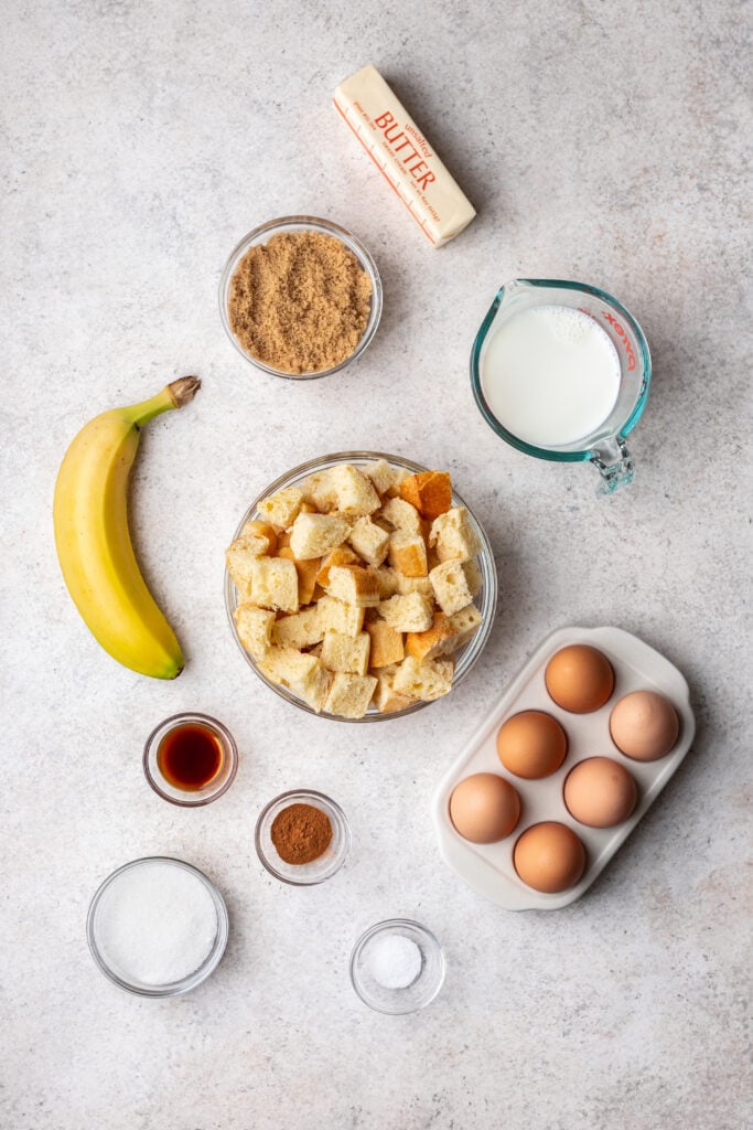 bowls of ingredients like bread cubes, eggs, milk, banana