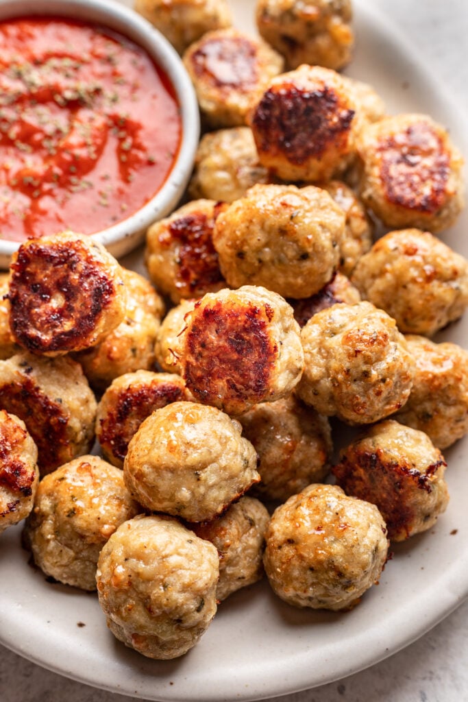 chicken meatballs on a platter with marinara dipping sauce