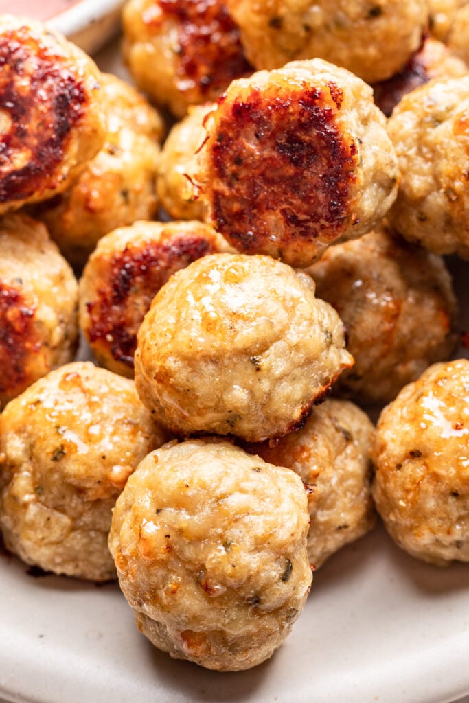 chicken meatballs on a platter with marinara dipping sauce