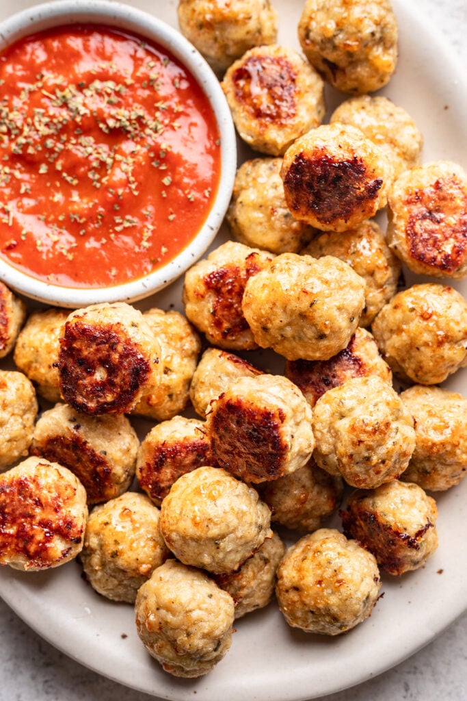 chicken meatballs on a platter with marinara dipping sauce