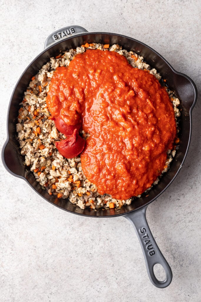 skillet with sauteed veggies, ground meat and marinara sauce