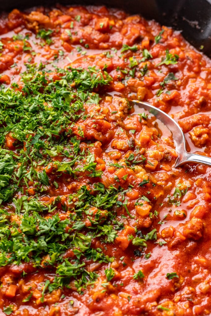 spoon scooping bolognese sauce