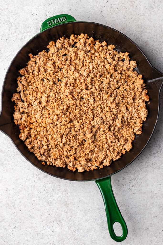 ground turkey cooked with spices in a cast iron skillet