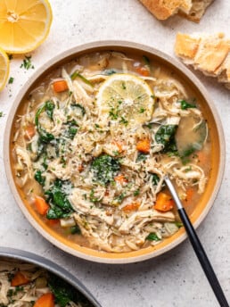 bowl of chicken lemon orzo soup with a spoon
