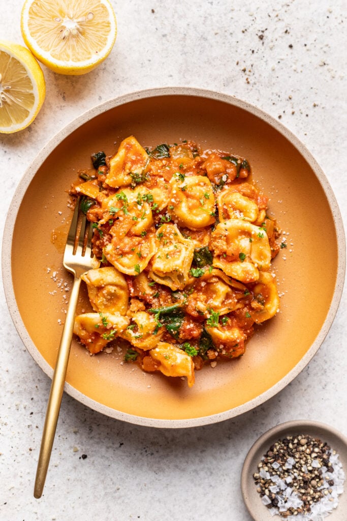 tortellini pasta in a bowl with a fork