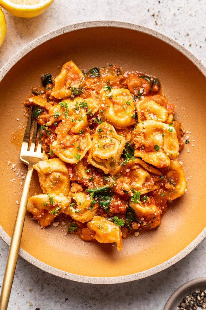 tortellini pasta in a bowl with a fork
