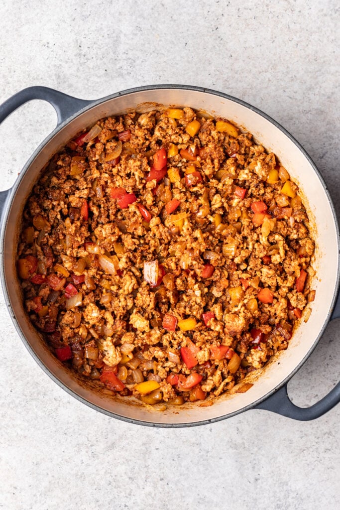 large pot with chopped veggies and ground chicken