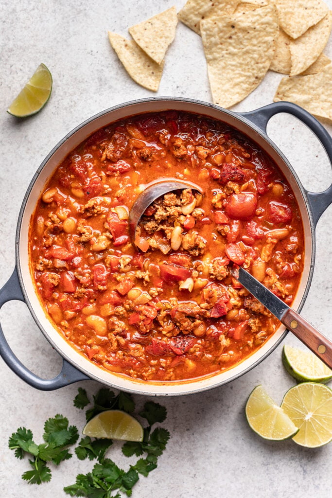 large pot of chicken chili with a ladle