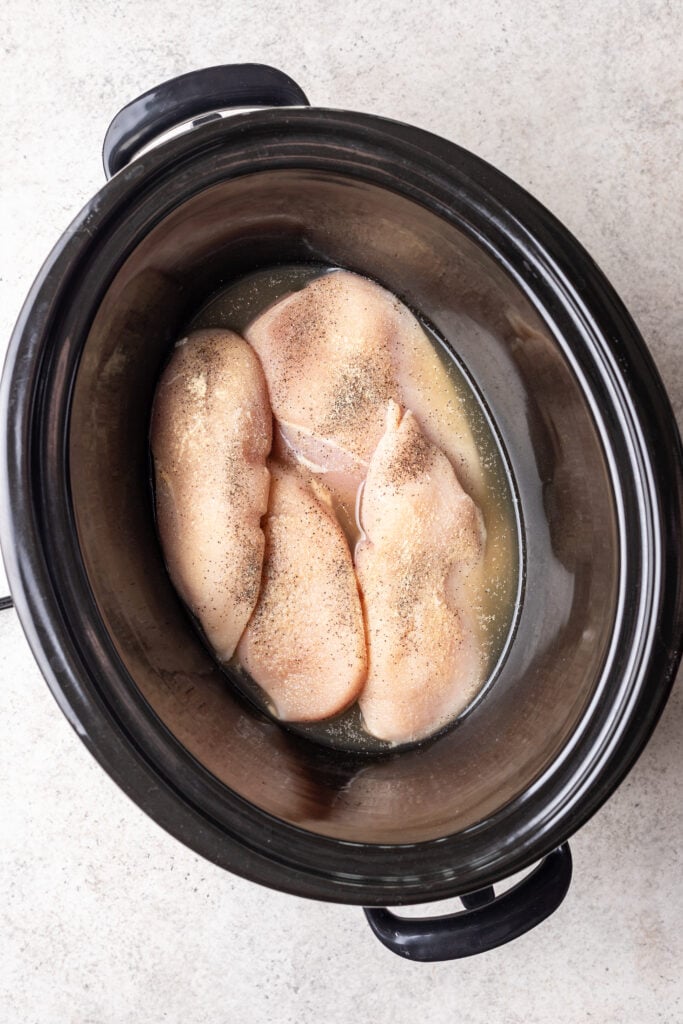 raw chicken breasts in a slow cooker