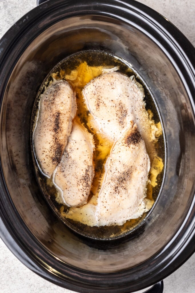 cooked chicken breasts in a slow cooker