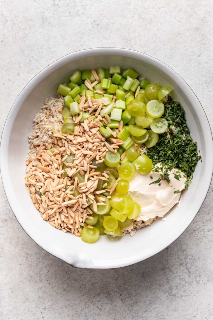 shredded chicken, celery, grapes, tarragon, almonds and mayonnaise in a large bowl