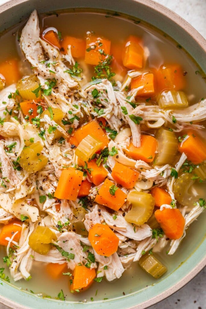 close up of chicken noodle soup with carrots and celery