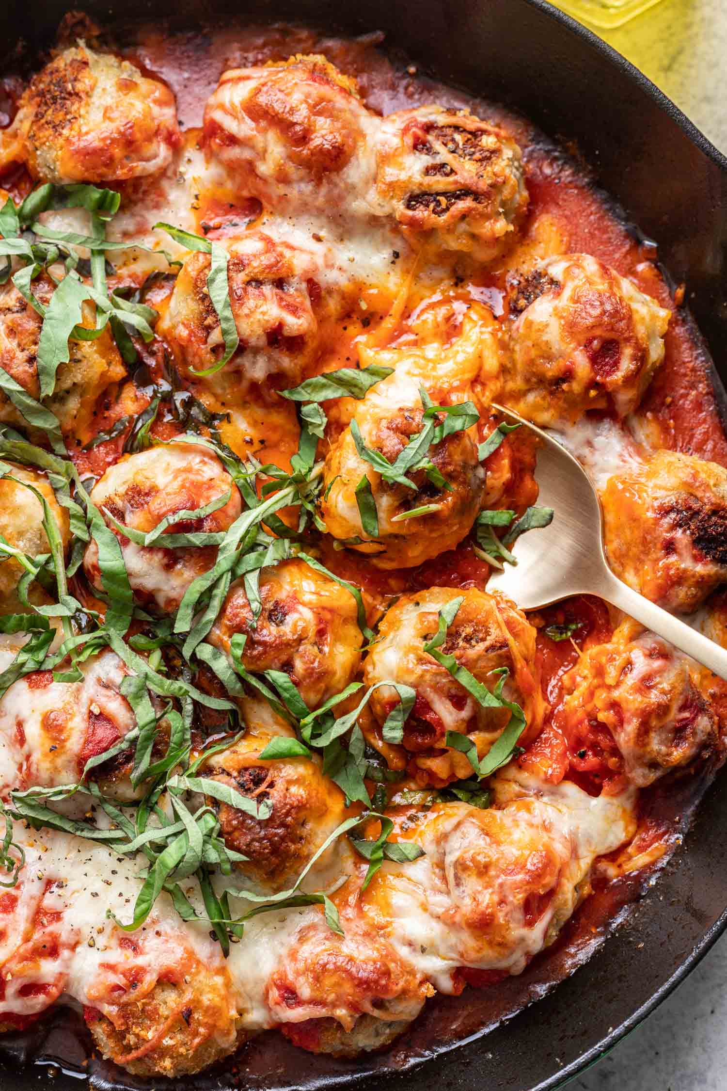 a spoon scooping a chicken meatball