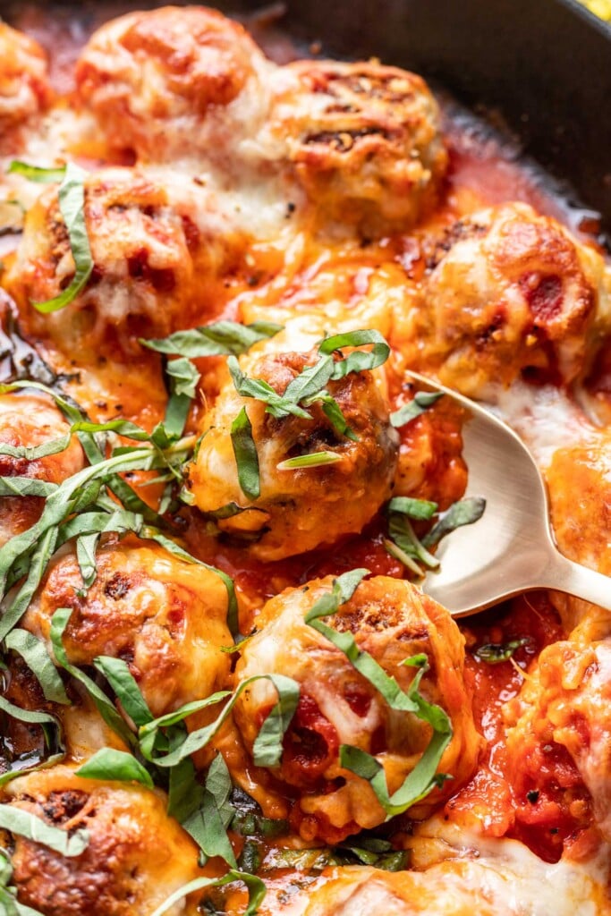 a spoon scooping a chicken parmesan meatball