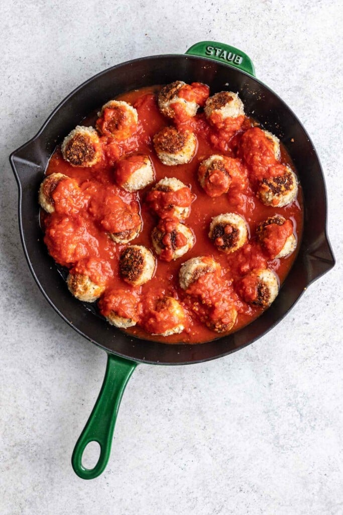 meatballs in a skillet with marinara sauce