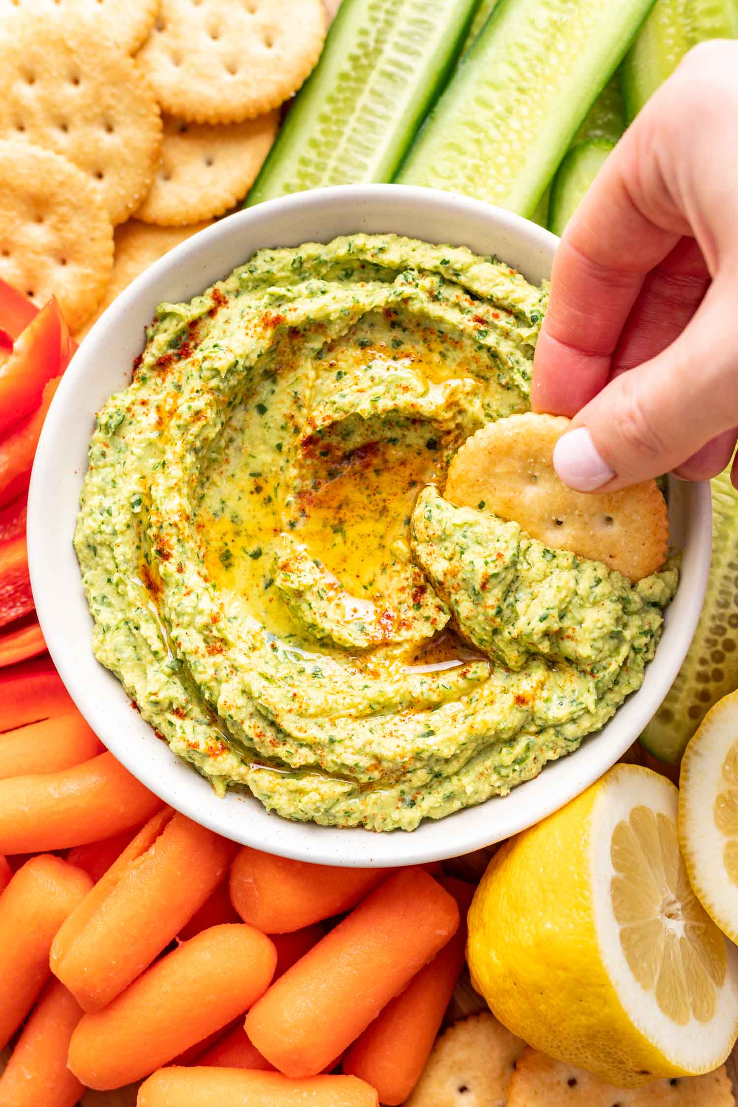 a cracking dipping into green dip