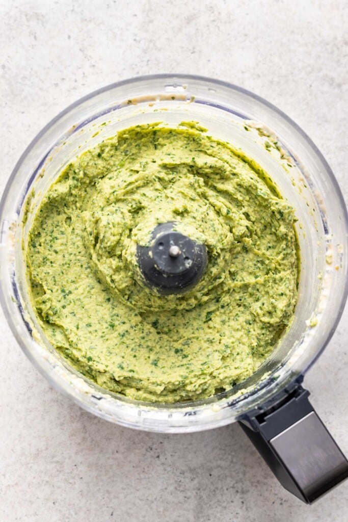 green herb avocado dip in a food processor