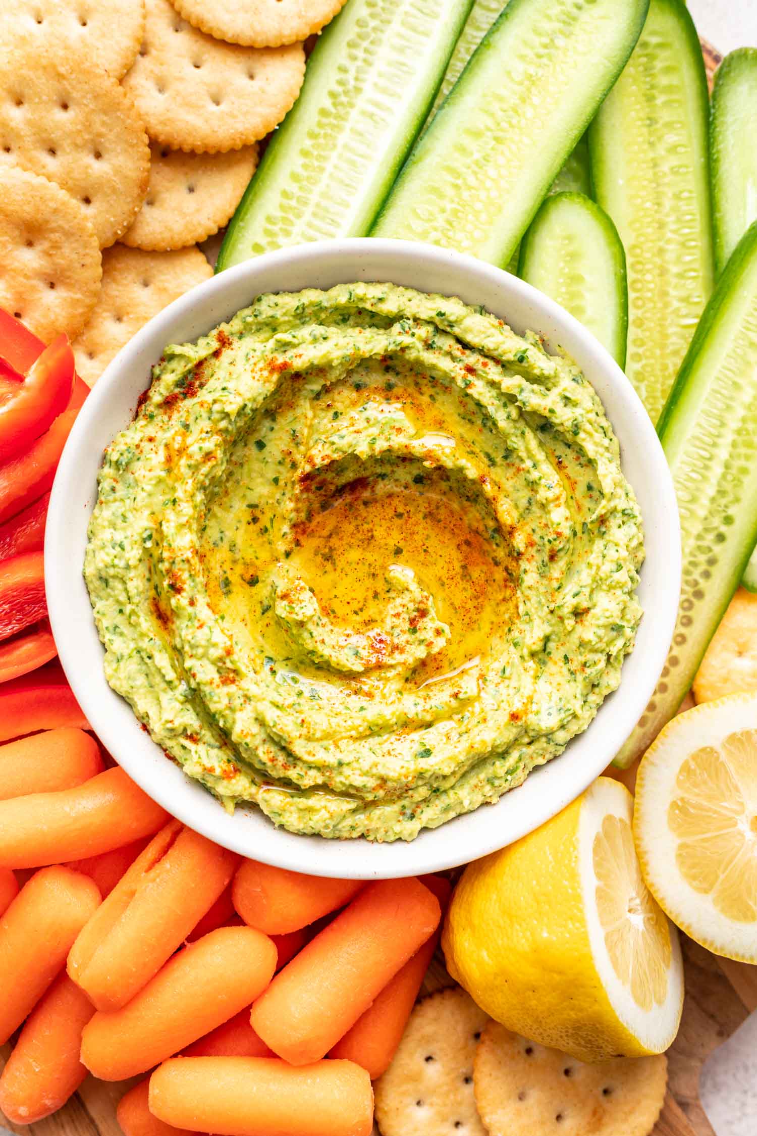 herby avocado dip on a platter with veggies