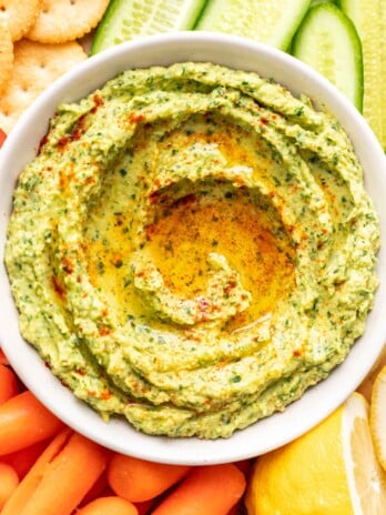 herby avocado dip on a platter with veggies