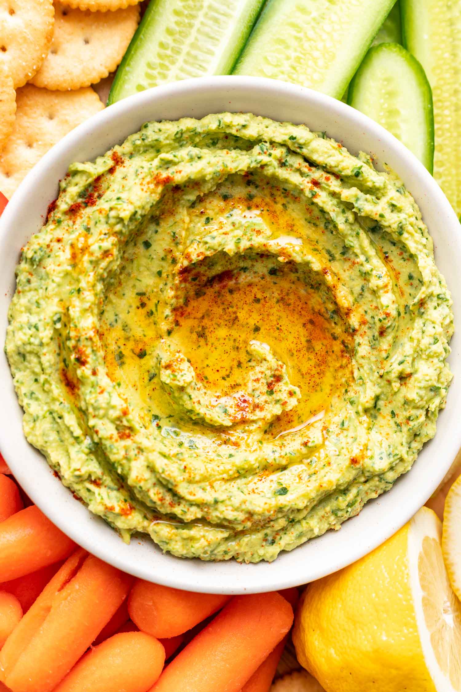 herby avocado dip on a platter with veggies