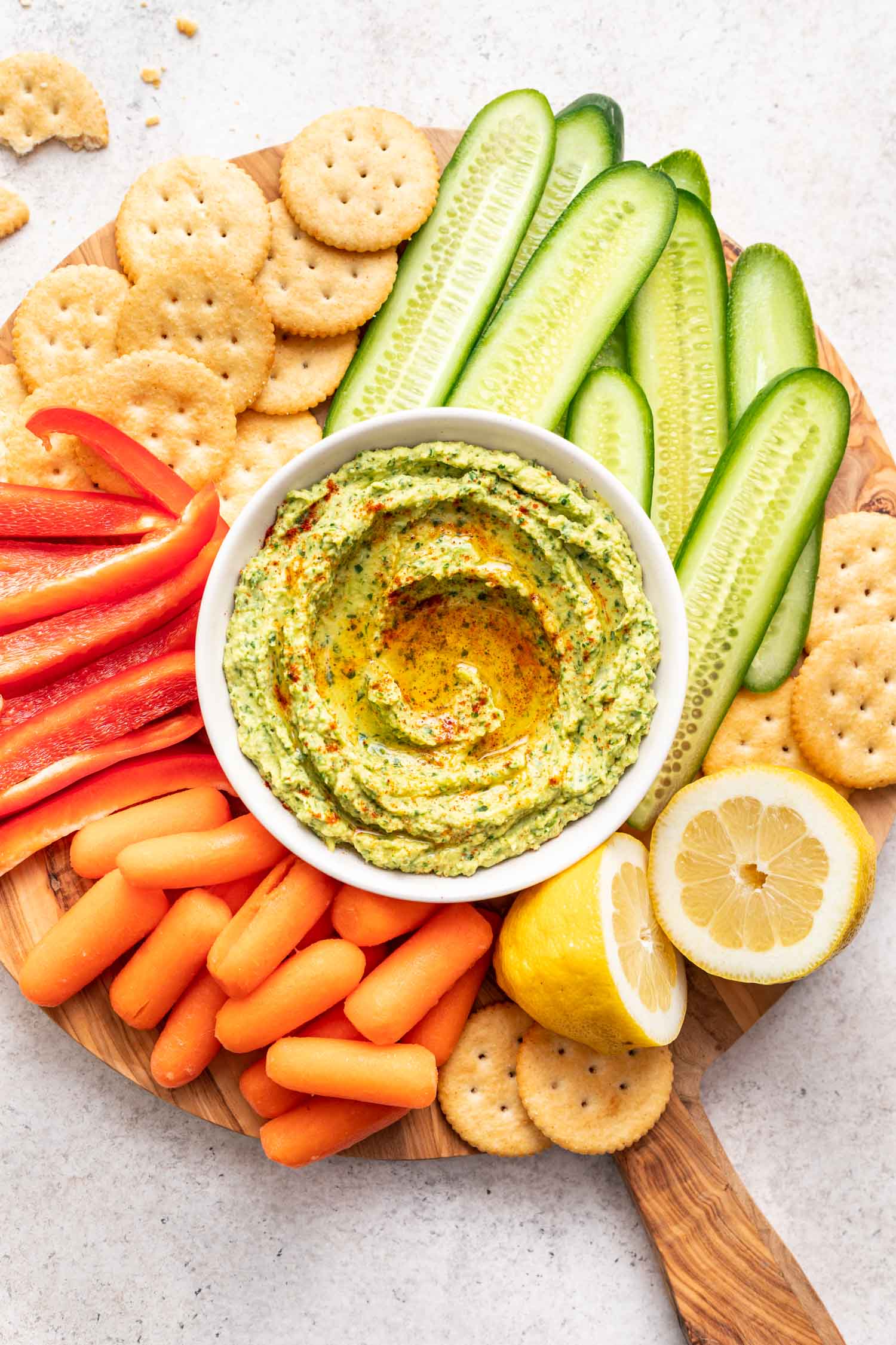 herby avocado dip on a platter with veggies