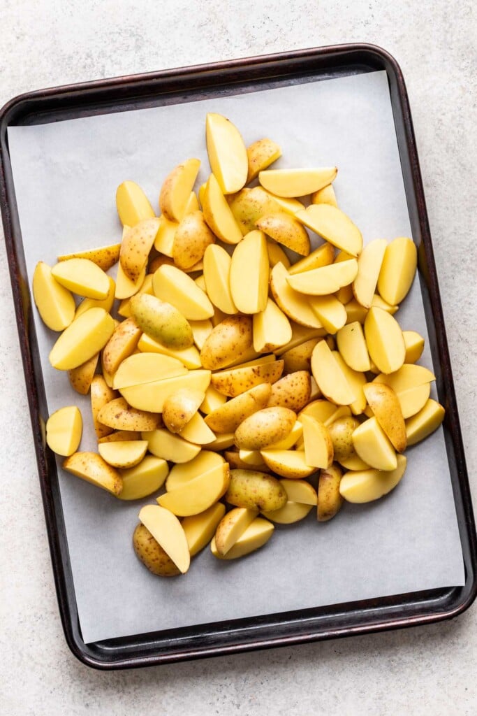 cut yukon gold potatoes on a sheet pan in a large pile