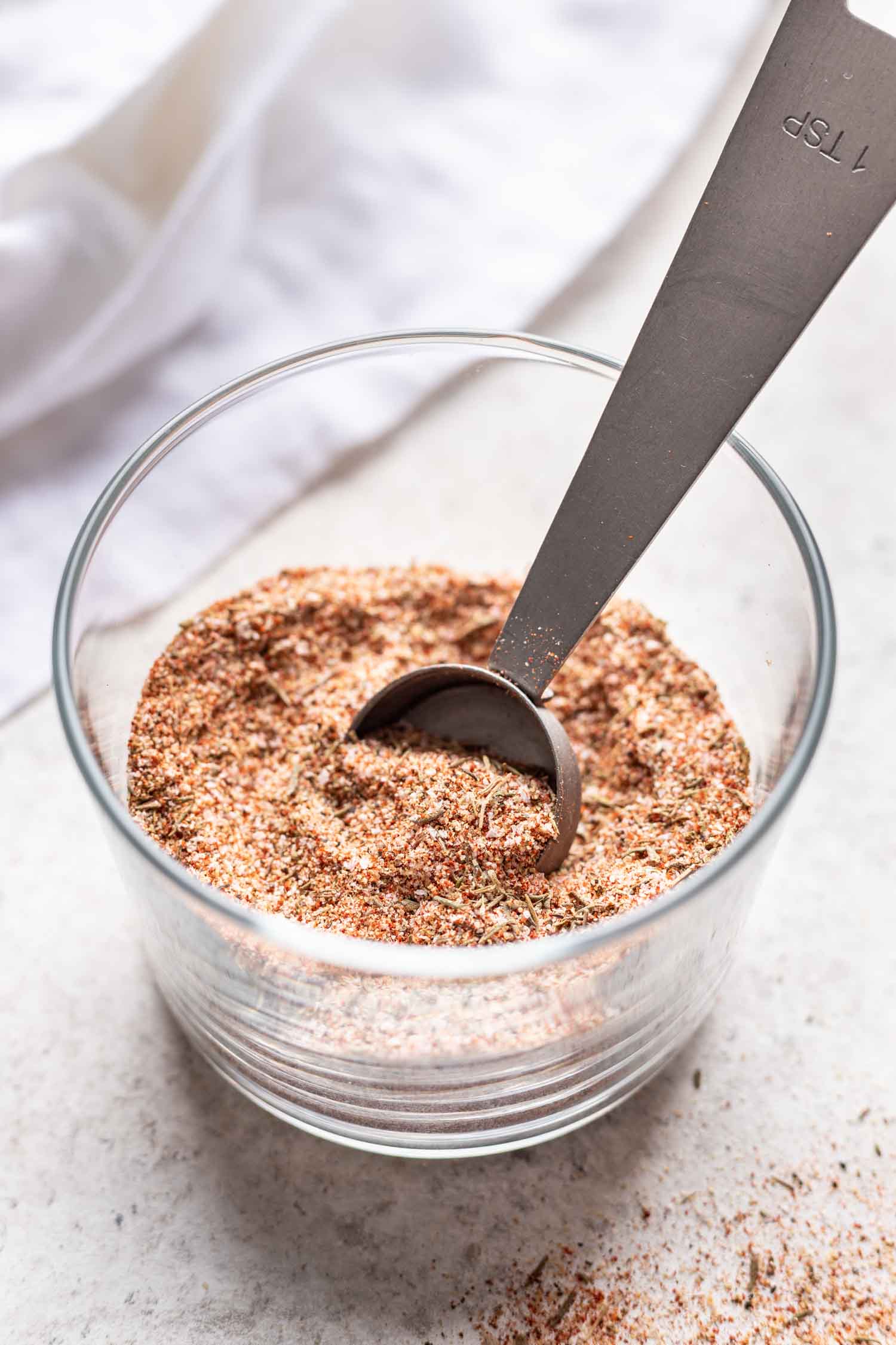 spice mixture in a glass with a measuring spoon