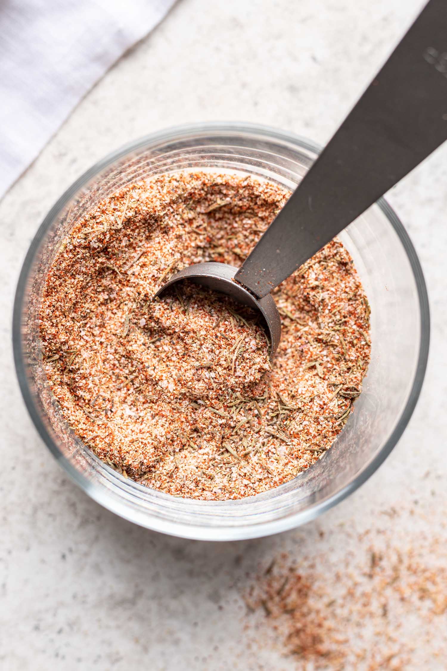 spice mixture in a glass with a measuring spoon