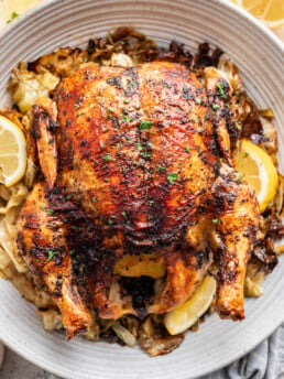 Whole Lemon Sumac Roast Chicken on a white platter