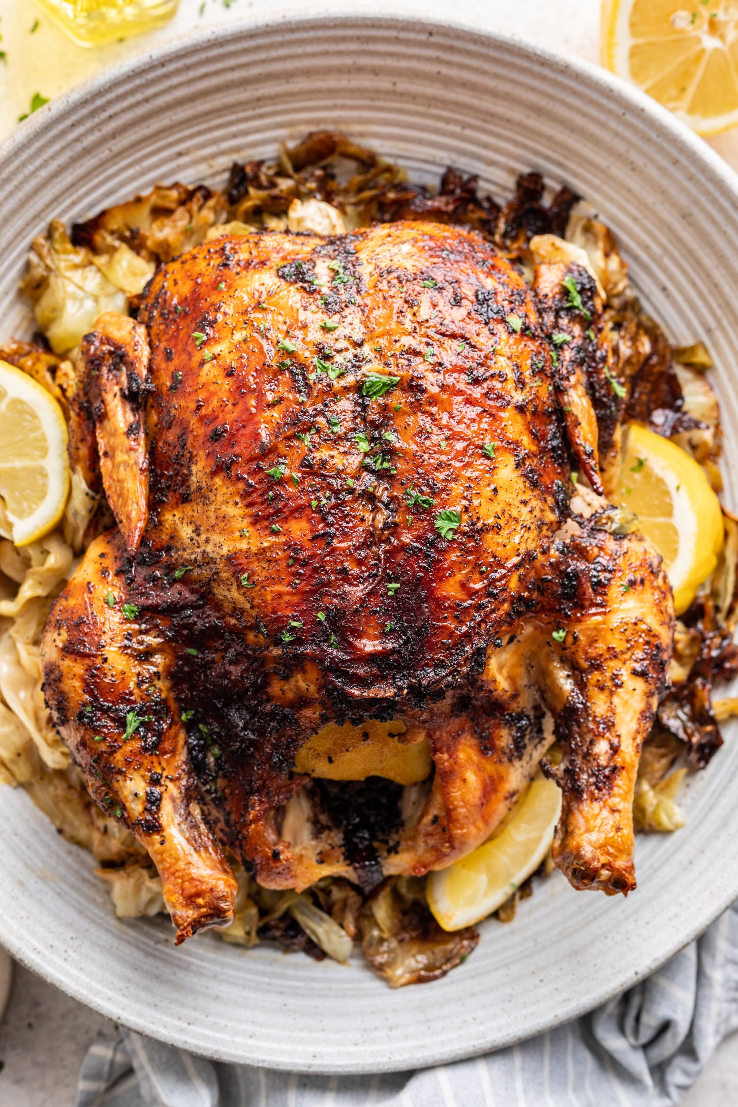 Whole Lemon Sumac Roast Chicken on a white platter
