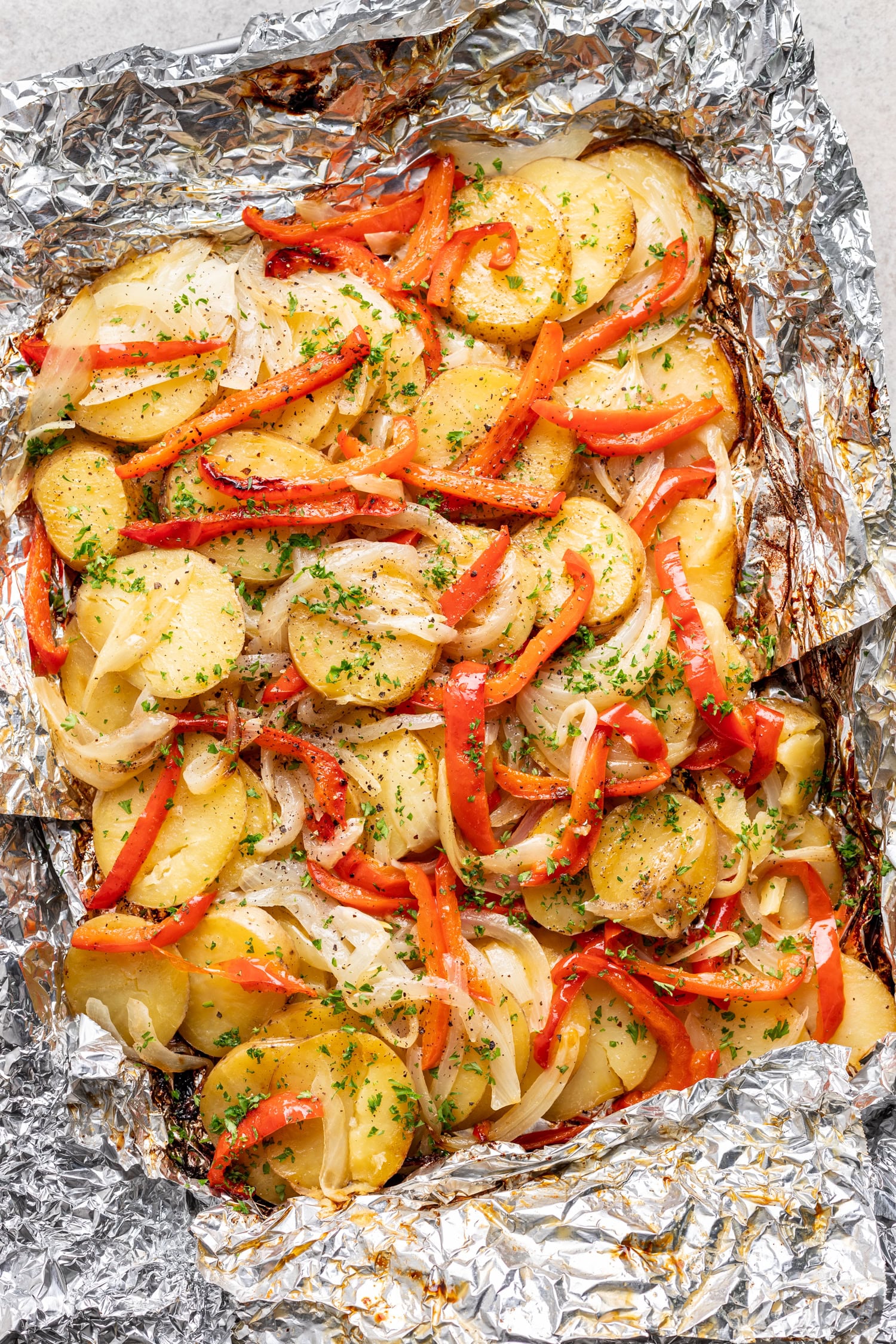 grilled potatoes, onions and bell peppers wrapped in foil