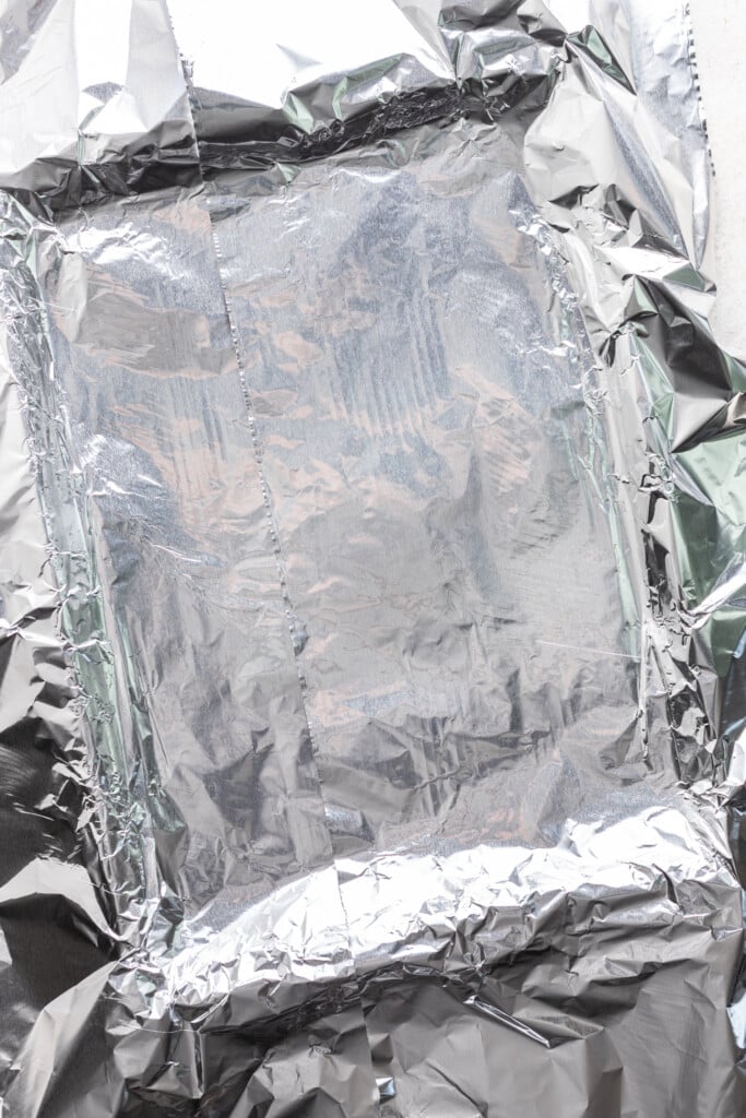 sheet pan covered with foil with extra foil hanging over