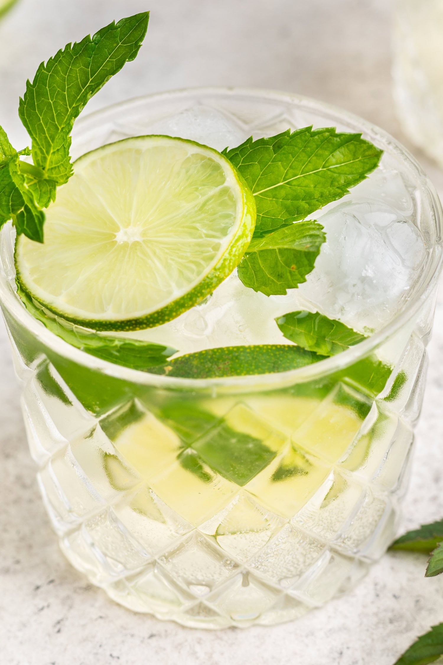 close up of a cocktail with fresh lime and mint