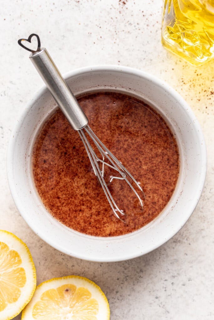 bowl of dressing with a whisk