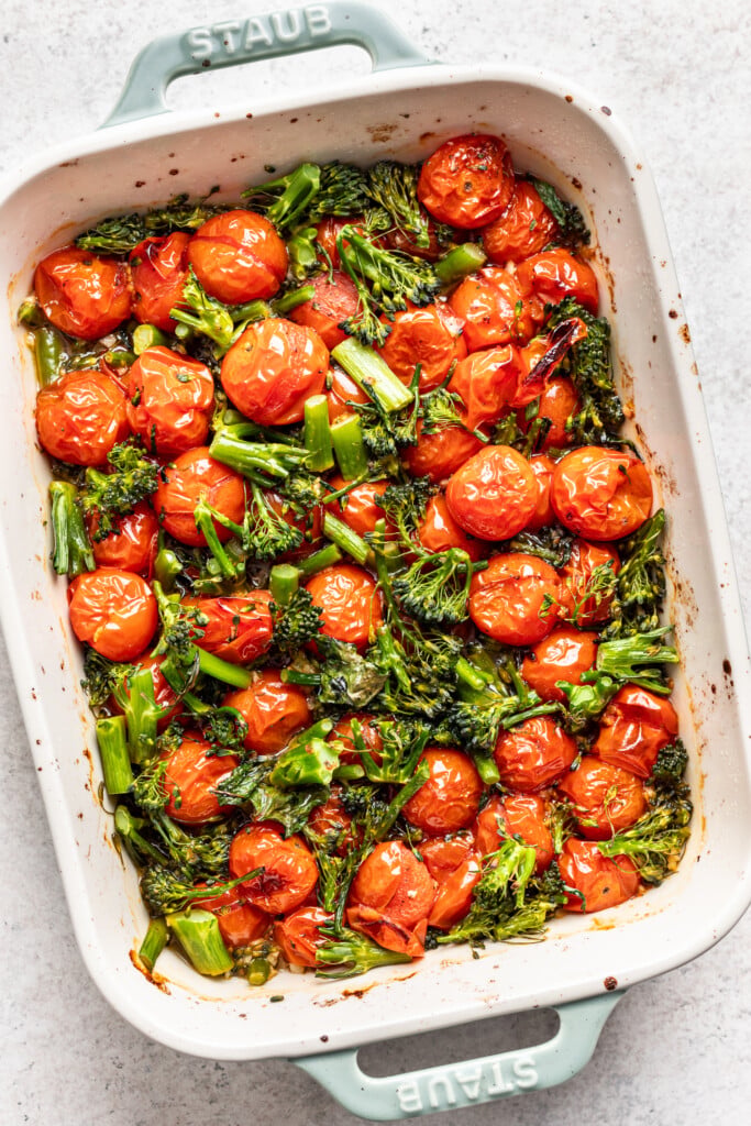 baking dish with roasted cherry tomatoes and broccolini