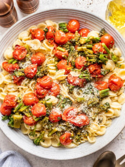 large bowl with pasta and roasted cherry tomatoes and broccolini