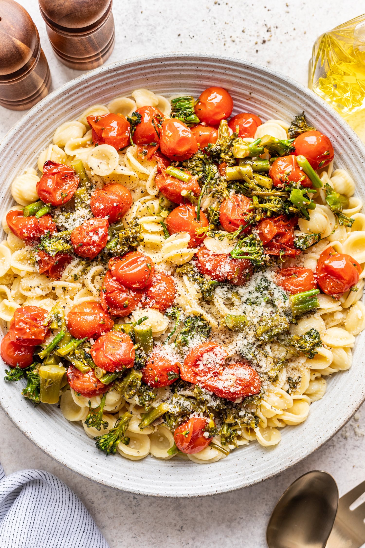large bowl with pasta and roasted cherry tomatoes and broccolini