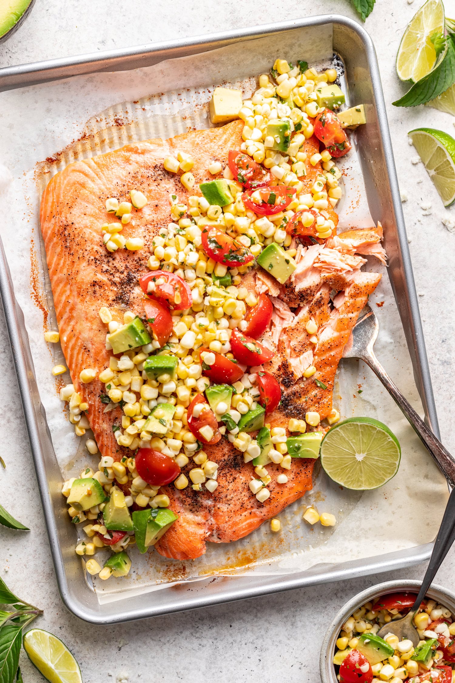 large piece of salmon with fresh corn salsa spooned on top