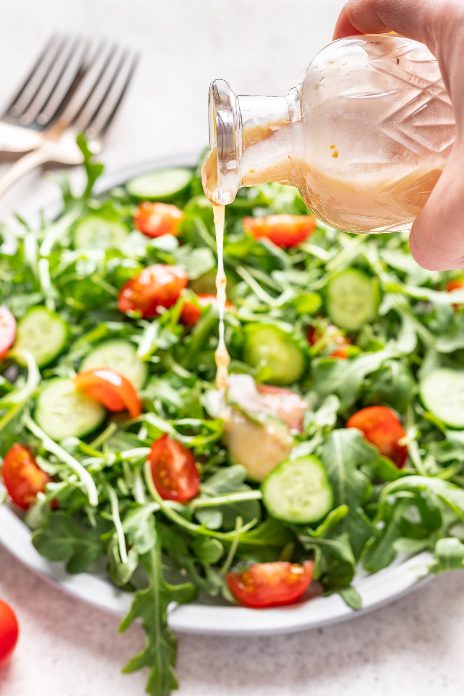 salad with dressing pouring on top
