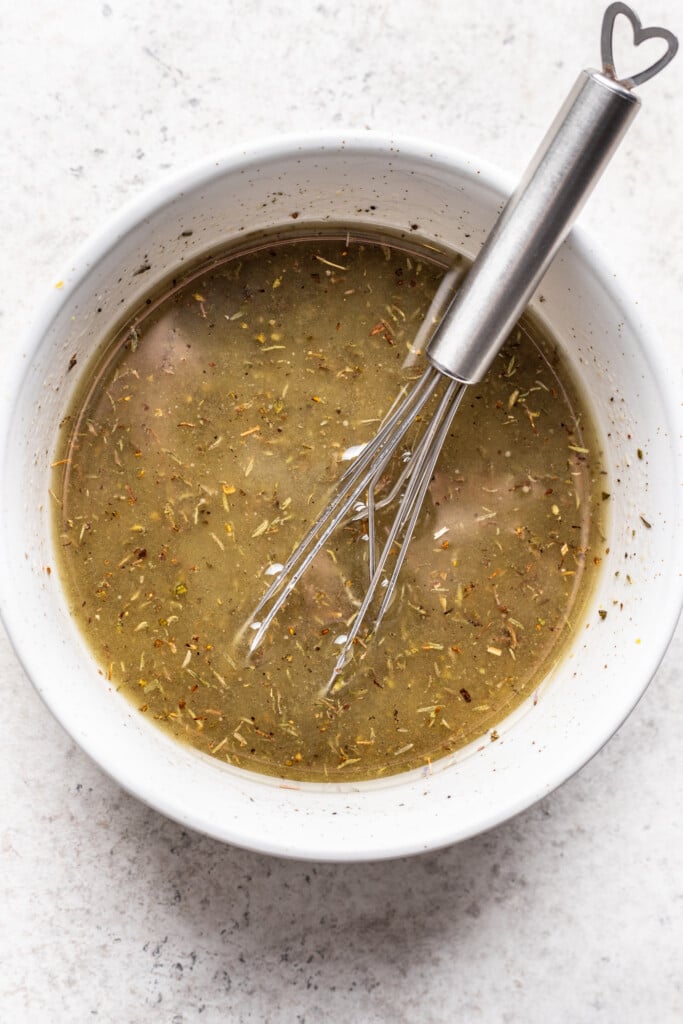 bowl with marinade and a whisk