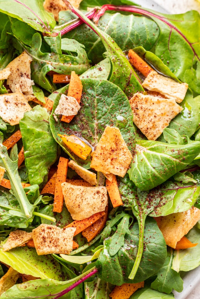 green salad with dressing on top