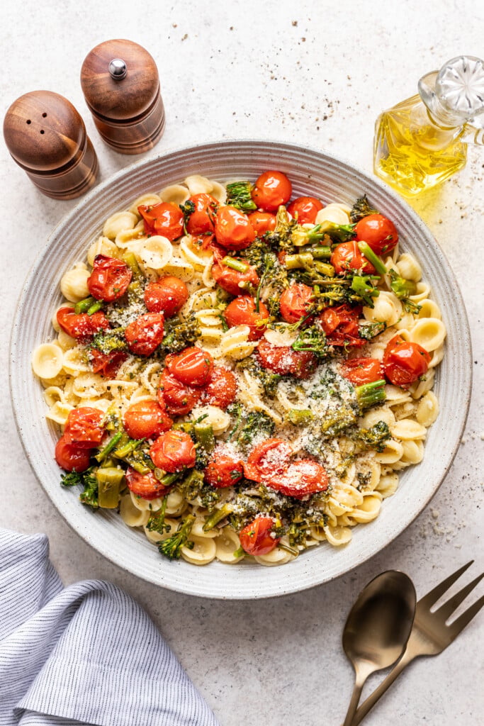 bowl of roasted tomatoes and broccolini over pasta