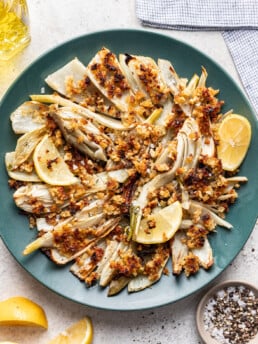 roast fennel on a blue platter with breadcrumbs