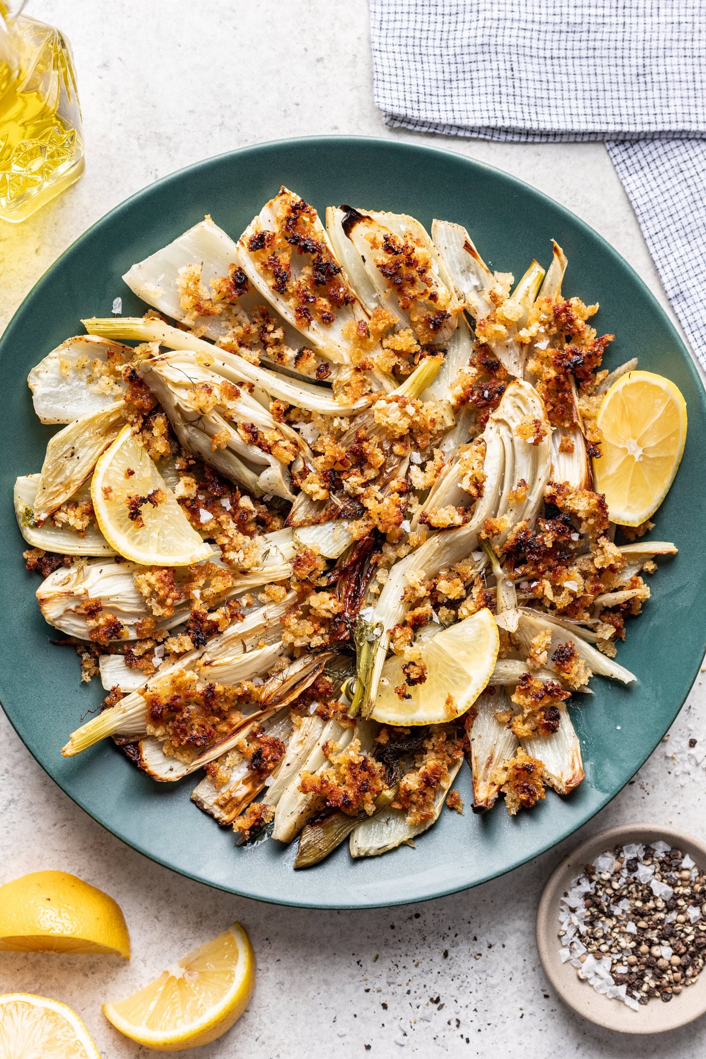 roast fennel on a blue platter with breadcrumbs