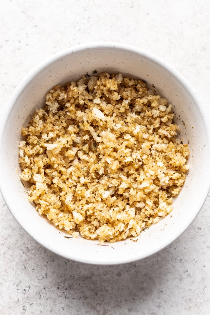 a white bowl with breadcrumbs