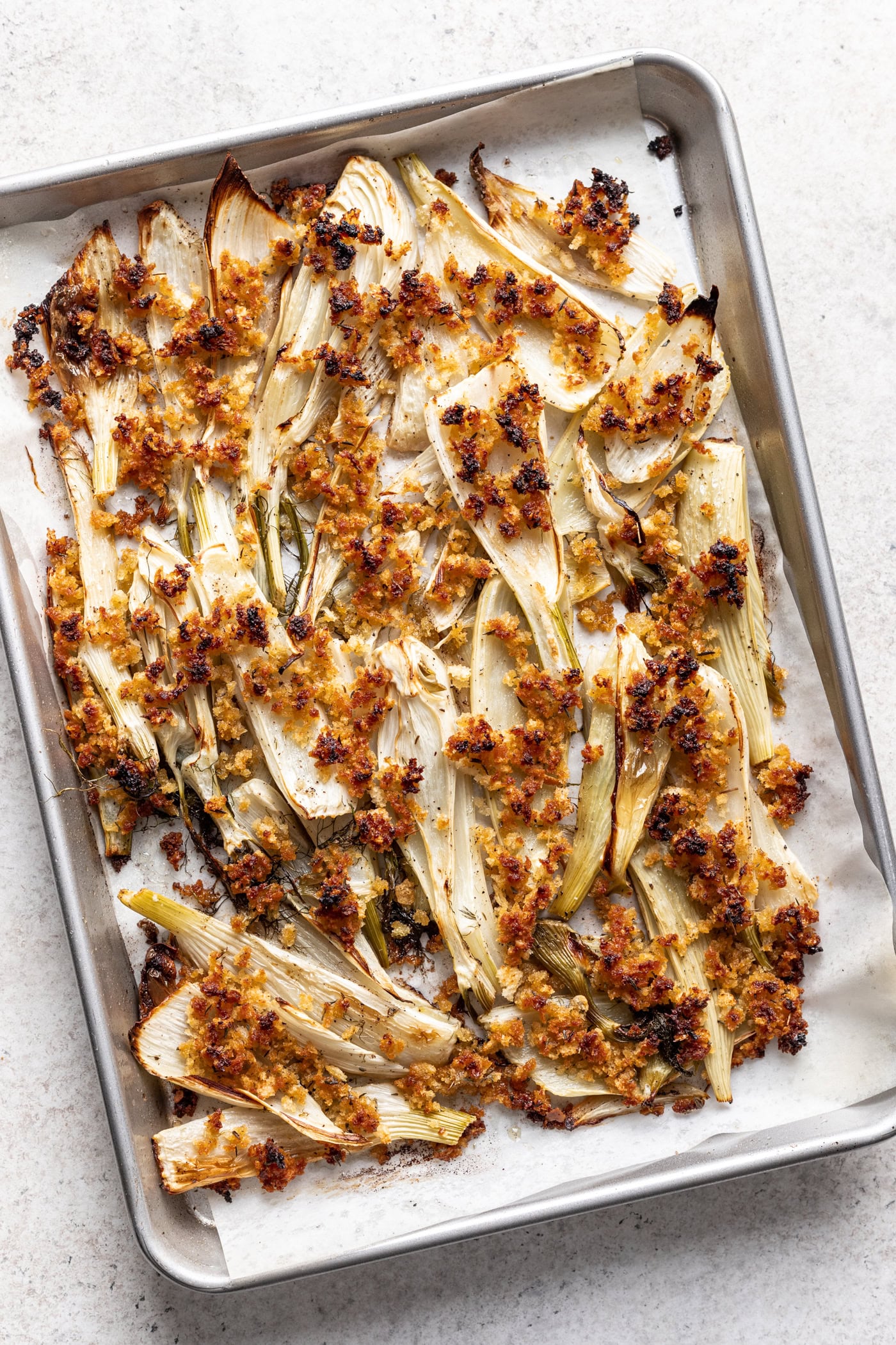 roast fennel on a sheet pan with breadcrumbs on top