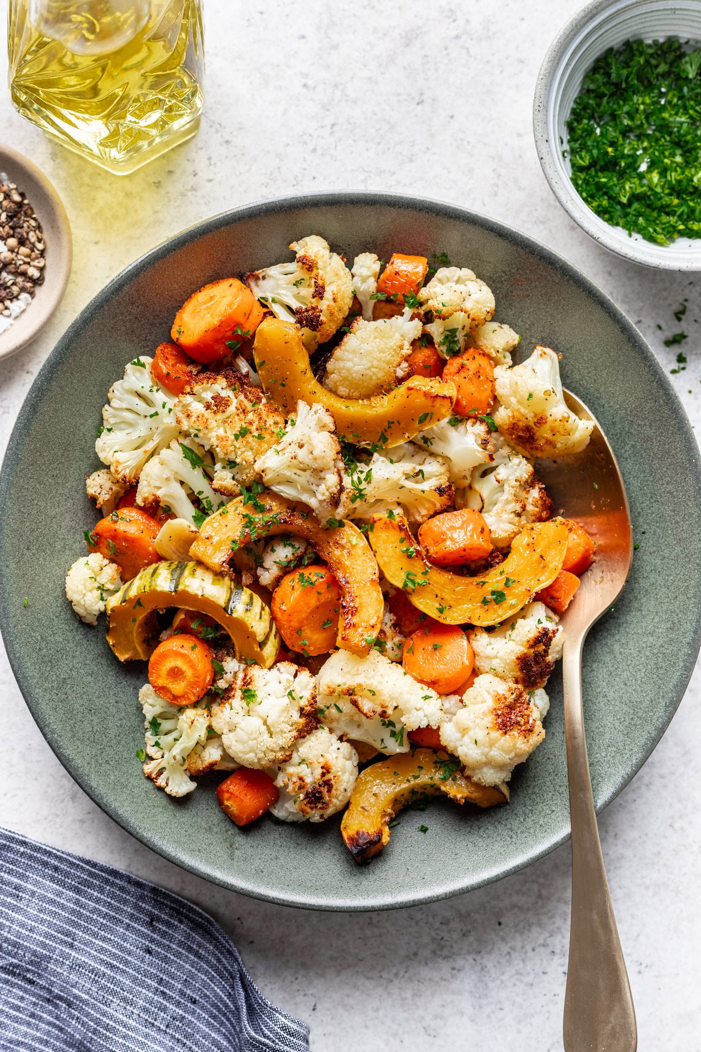 roasted veggies in a bowl with a serving spoon