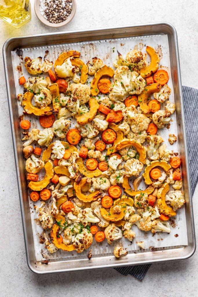 diced roasted veggies on a sheet pan with olive oil and spices