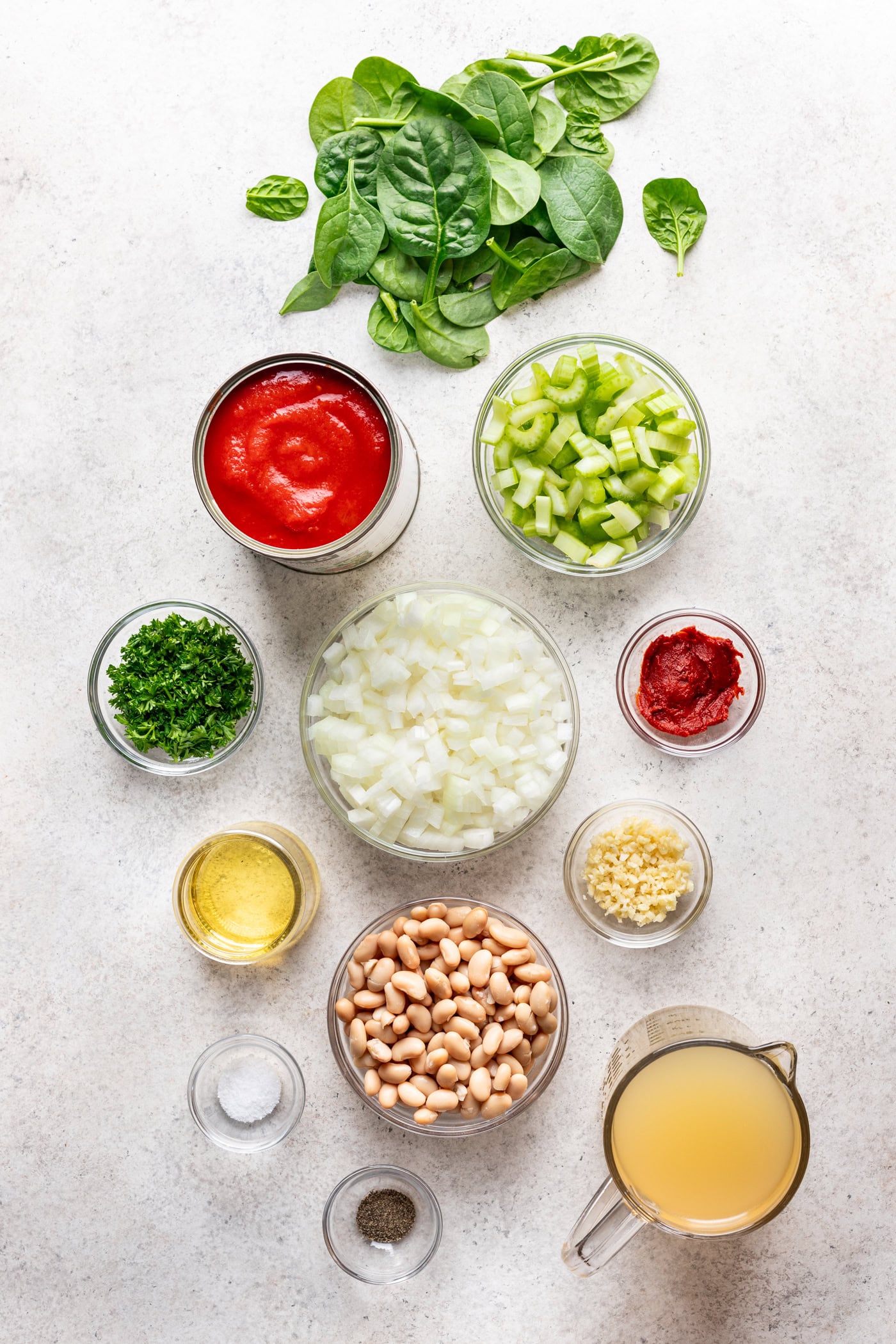 small bowls of prepped ingredients on a grey background