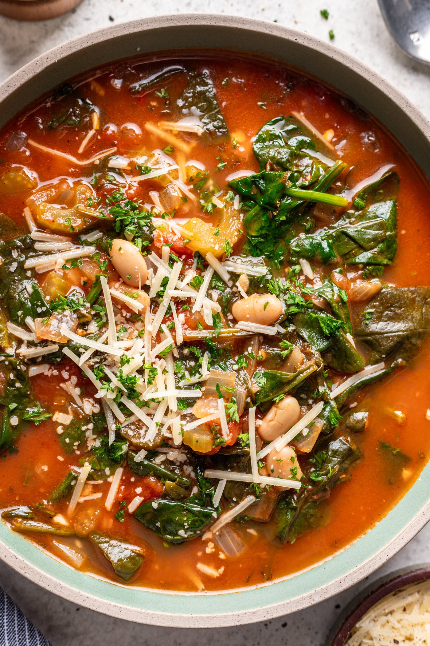 bowl of red soup topped with parmesan cheese